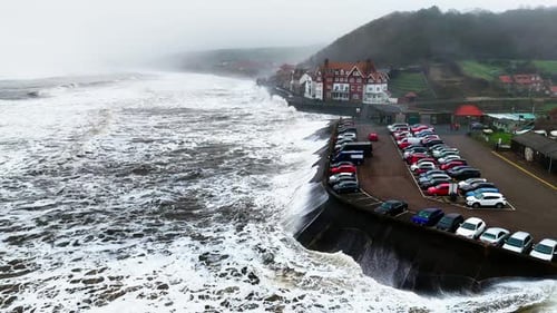 Stormy winter scene. Rough seas of the English coast with mist and fog. Aerial footage of the sleepy