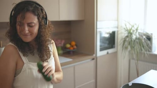 Woman Dancing and Singing in Bright Kitchen