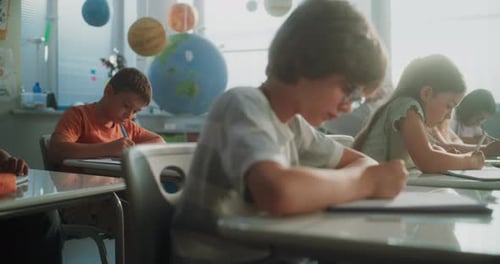 Primary School Children Writing School Test Doing Tasks in Notebooks