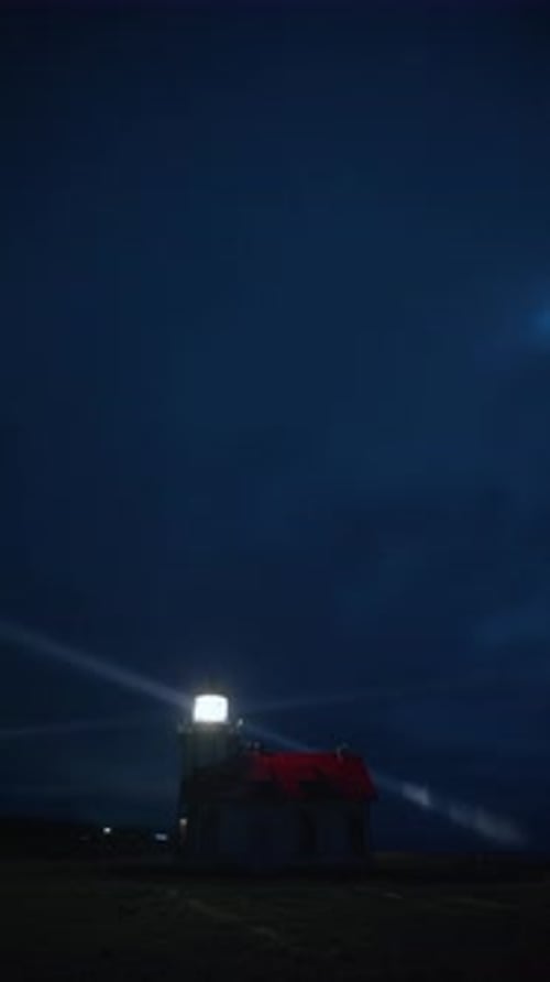 Vertical Lighthouse Beacon Shining Through Night Fog