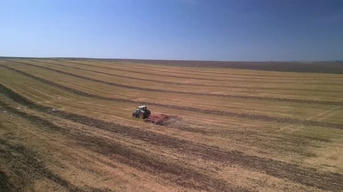 Tractor working on the field doing tillage with cultivator