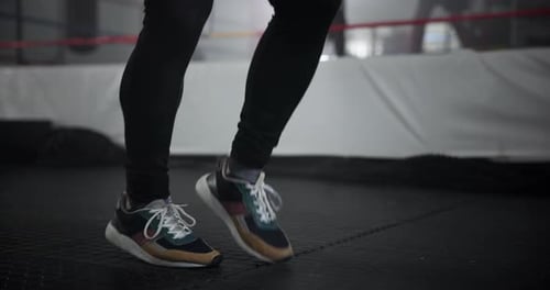 Legs, person and skipping with rope at gym for wrestling match, workout