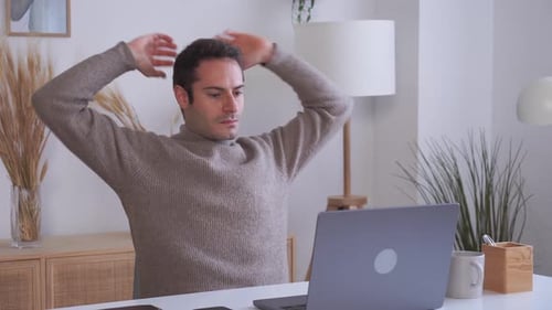 Man Working on Laptop Doing Stretching Exercises