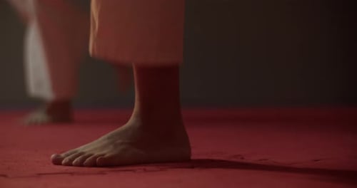 Bare Feet of Karateka Train Kick on Mat of Martial Arts Club