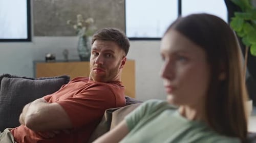 Disagreement Between Man and Woman on Couch