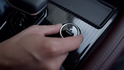 Close Up View of Switching Driving Mode in Luxury Car Using Rotary Switch Eco Comfort and Sport