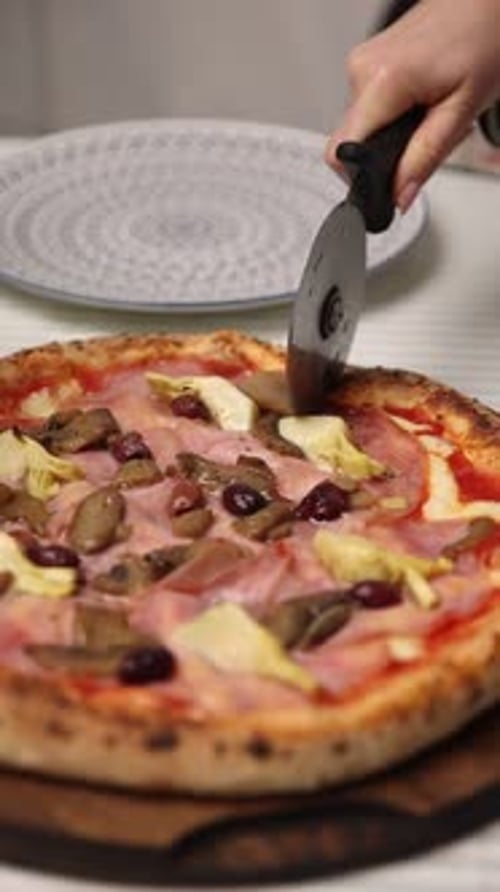 The chef makes delicious pizza in a professional kitchen.