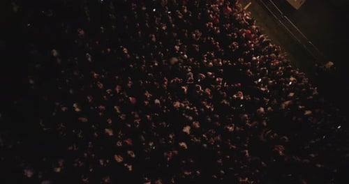 Aerial View of Large Crowd at Night Event