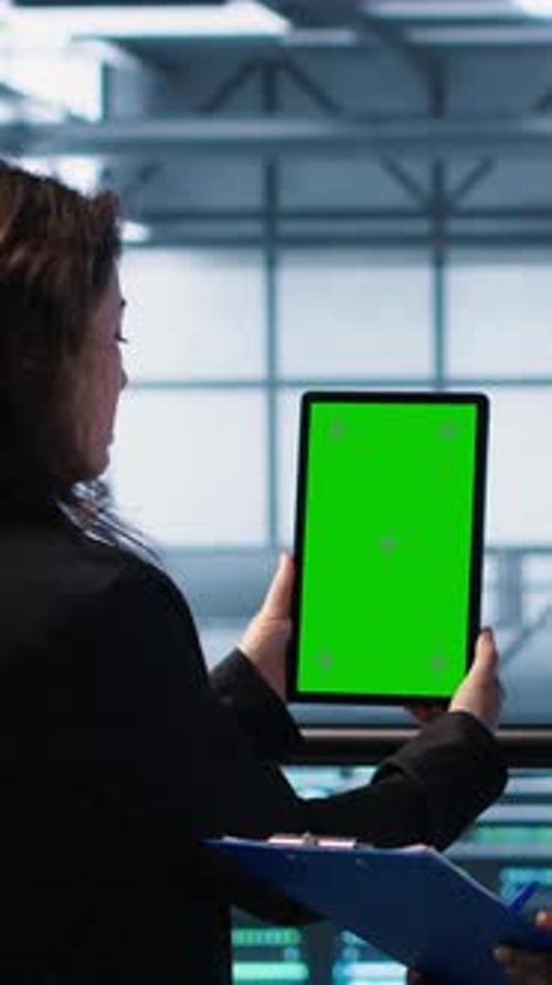 Vertical Video Computer Scientists in Data Center Use Mockup Tablet Inspecting Server Rigs