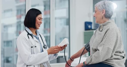 Healthcare, blood pressure or checkup with a doctor and patient in the hospital for a health