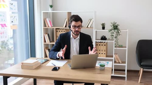 Business Professional Engaging in Video Call with Headset in Modern Office