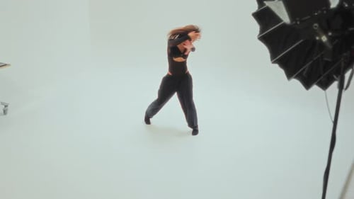Woman Dances Gracefully in a Bright White Studio