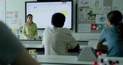 School Children in Classroom listening to Teacher