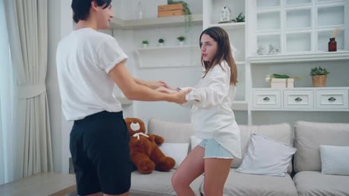Young Couple Dancing Together at Home