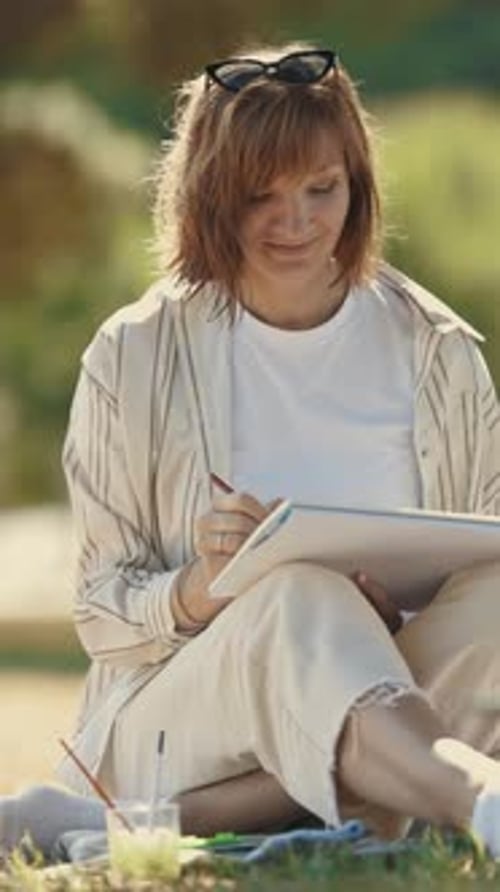 The Artist Draws Her Friend Sitting in the Park