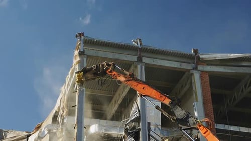 Excavator Destroys Stadium Concrete Support Under Blue Sky