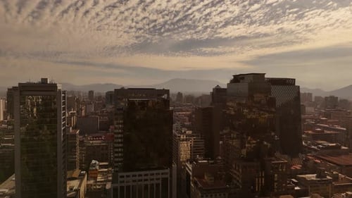 Aerial rising shot of three modern skyscraper Buildings with mirrored window. Foggy landscape with g