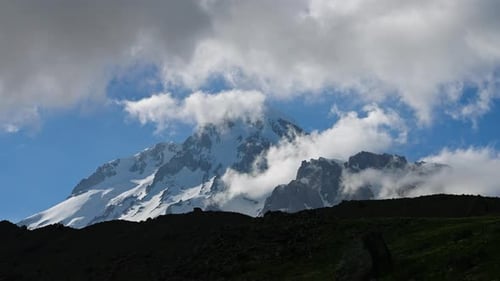 Timelapse of Kazbegi Mountain in Caucasus Ridge Clouds Move Around the Snowy Peak Majestic Scenery