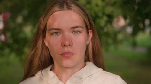 Young Lady with Bold Expression and Intense Gaze in Natural Outdoor Setting