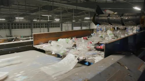 Recycling Plant For Plastic Bottles and Aluminum Cans on a Conveyor Belt. Wide Shot