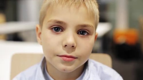 Happy smiling preteen boy facial expression in a school classroom education concept