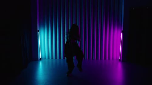 Woman Dances in Silhouette Lit by Neon Lights