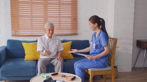 Senior Man Exercising with Nurse Supervision at Home