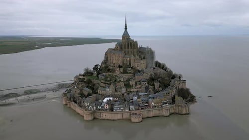 Mont Saint Michel during low tide, Normandy in France. Aerial orbiting