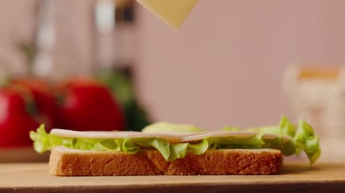 Making a Sandwich With Lettuce, Meat, and Cheese