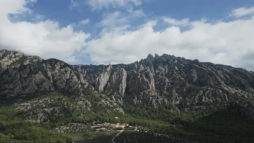 Aerial drone flying towards montserrat mountain range in barcelona
