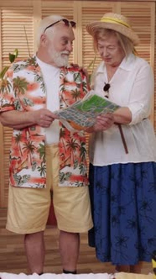 Senior Couple Planning Vacation with Map Indoors