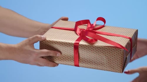 Passing Birthday Gift with Red Ribbon