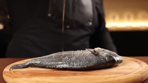 chef cooking fish in the kitchen. Close-up shots