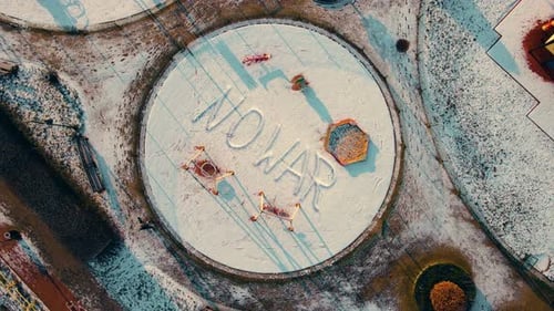 Empty Children Playground with Inscription NO WAR Writing at Snow in Winter During Russian War