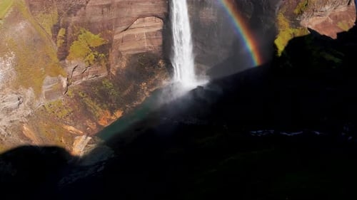 Beautiful Rainbow On Haifoss Waterfalls In Iceland In Summer. - aerial tilt up shot