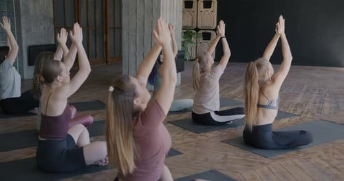 Women Practicing Yoga Together in Studio