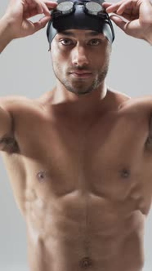 Man with Swim Cap Puts on Goggles