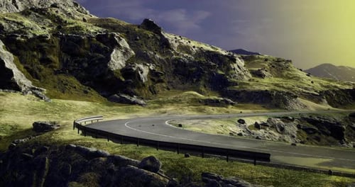 Scenic Winding Road Through Mountainous Terrain During Sunset Hour