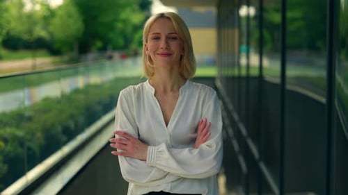Portrait of the Smiled Business Woman Wearing Formal Suit Crossing Hands Standing Near the Business