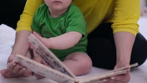 Loving Infant Reading Book with Adult at Home