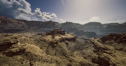 Vast Desert Landscape with Rugged Terrain Under a Clear Sky at Midday
