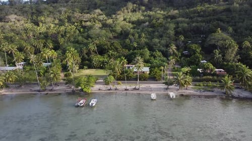 Low aerial flight along idyllic tropical shoreline of Bora Bora island