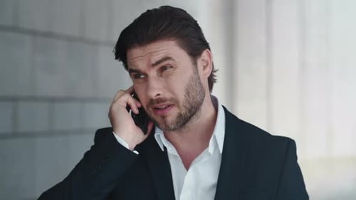 Businessman Talking on Phone, Checking Watch