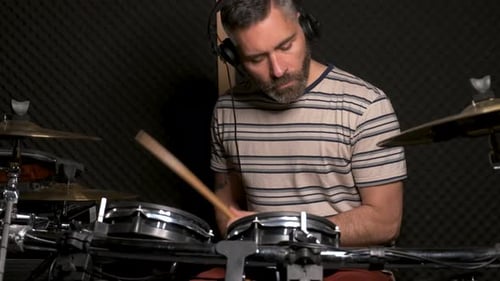 Drummer Man Playing Drums in a Recording Studio