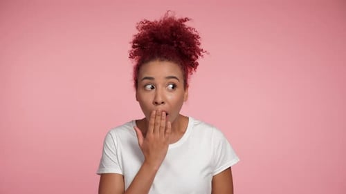 Close Up Excited Shocked African American Redhead Woman Covers Mouth with Palm