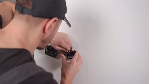 Man Installs Electrical Outlet Inside Home, Close Up