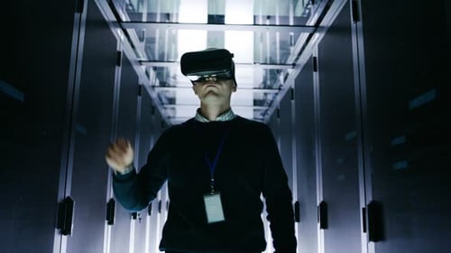 IT Engineer Wearing Virtual Reality Headset Works with Augmented Reality Software in Data Center. H