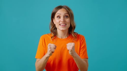 Excited Woman Celebrating Success on Blue Background