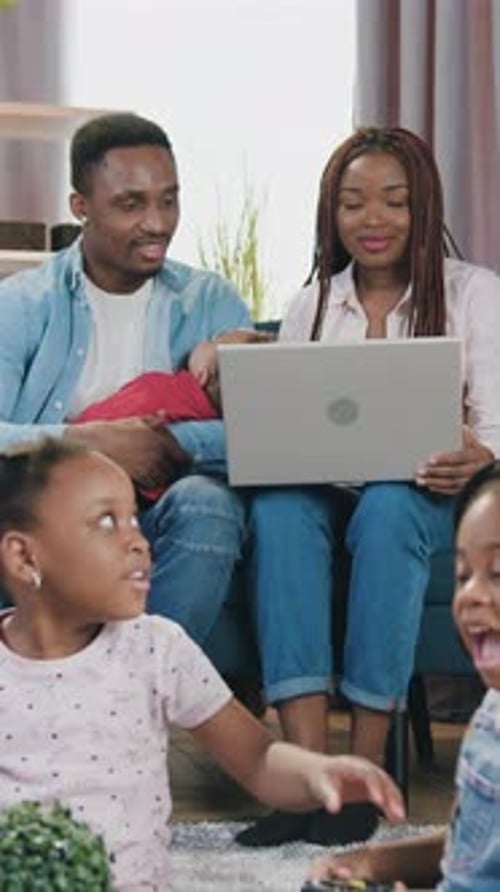 Young Family Relaxing Together with a Computer
