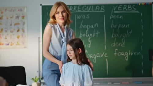 Elementary School Girl Answering Teacher Question at Blackboard Schoolgirl Sit